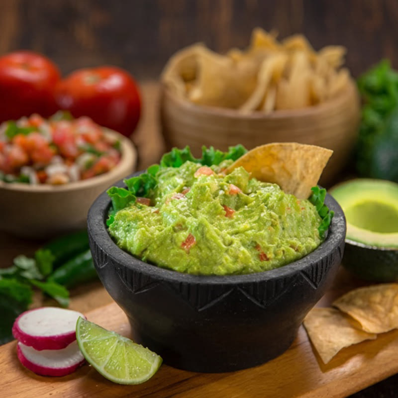 Fresh guacamole served with accompaniments
